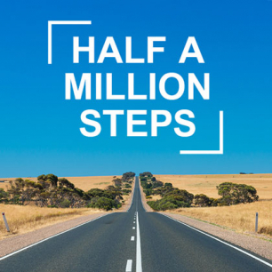 A country road stretches to the horizon. The text "Half a Million Steps" is emblazoned across the sky. 